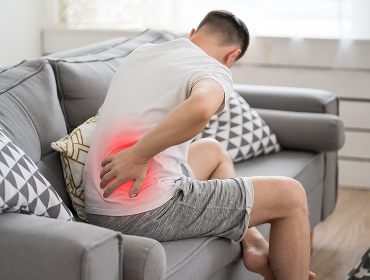 Man experiencing stiffness after sitting upright