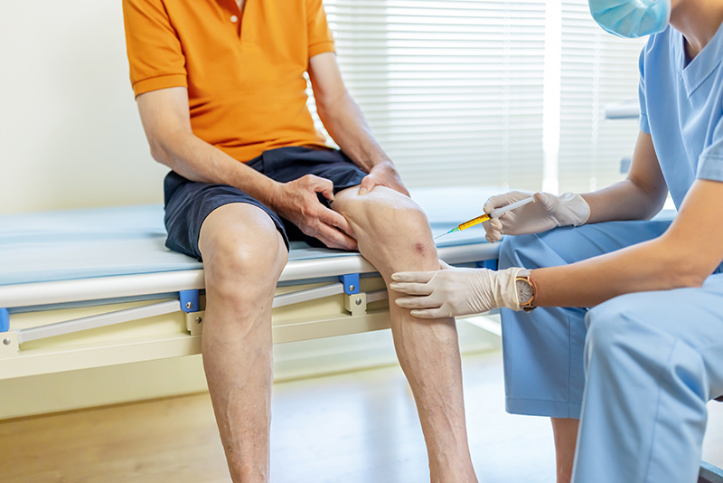 A doctor assessing a patient's knee before meniscus surgery